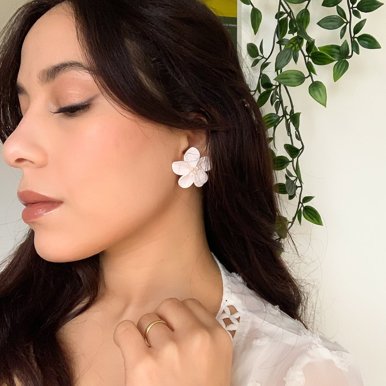 model wearing our white floral earrings