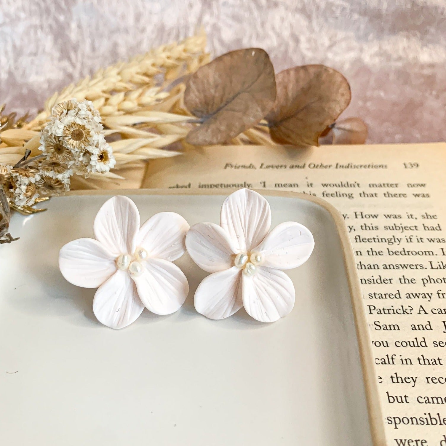 White flower stud earrings with 3 tiny pearls in the center