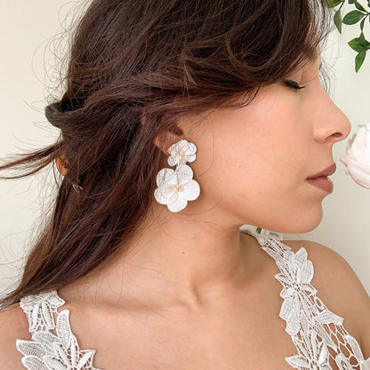 bride with a double floral statement earringd