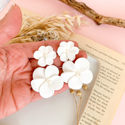 double floral bridal earrings taking the hand as a reference measurement