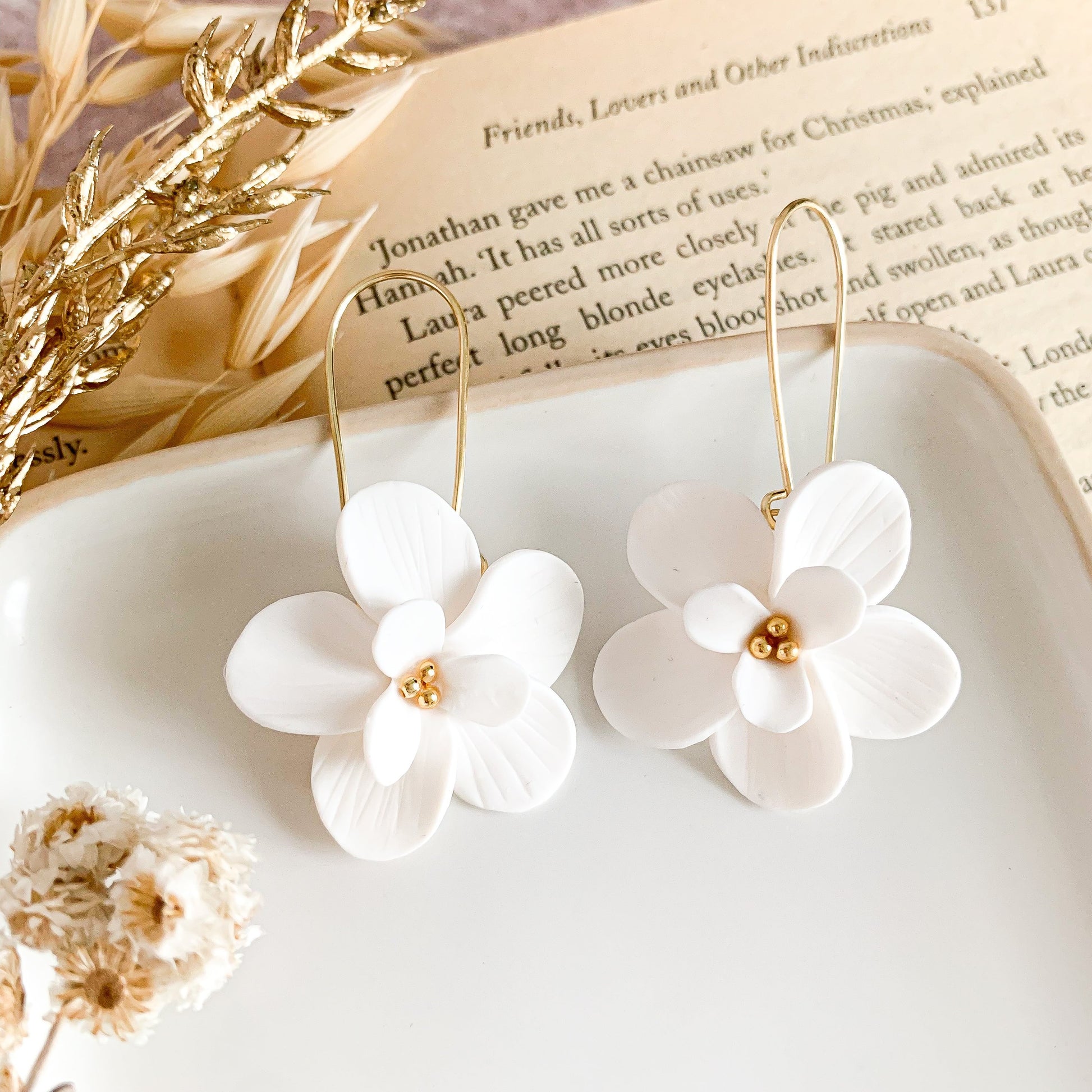 white flower dangle earrings with gold stainless steel tiny beads in the center