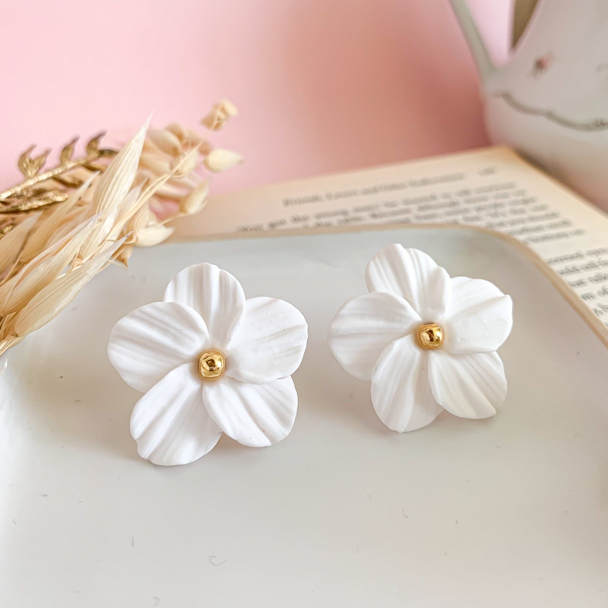 Flower stud earring with gold bead in the center