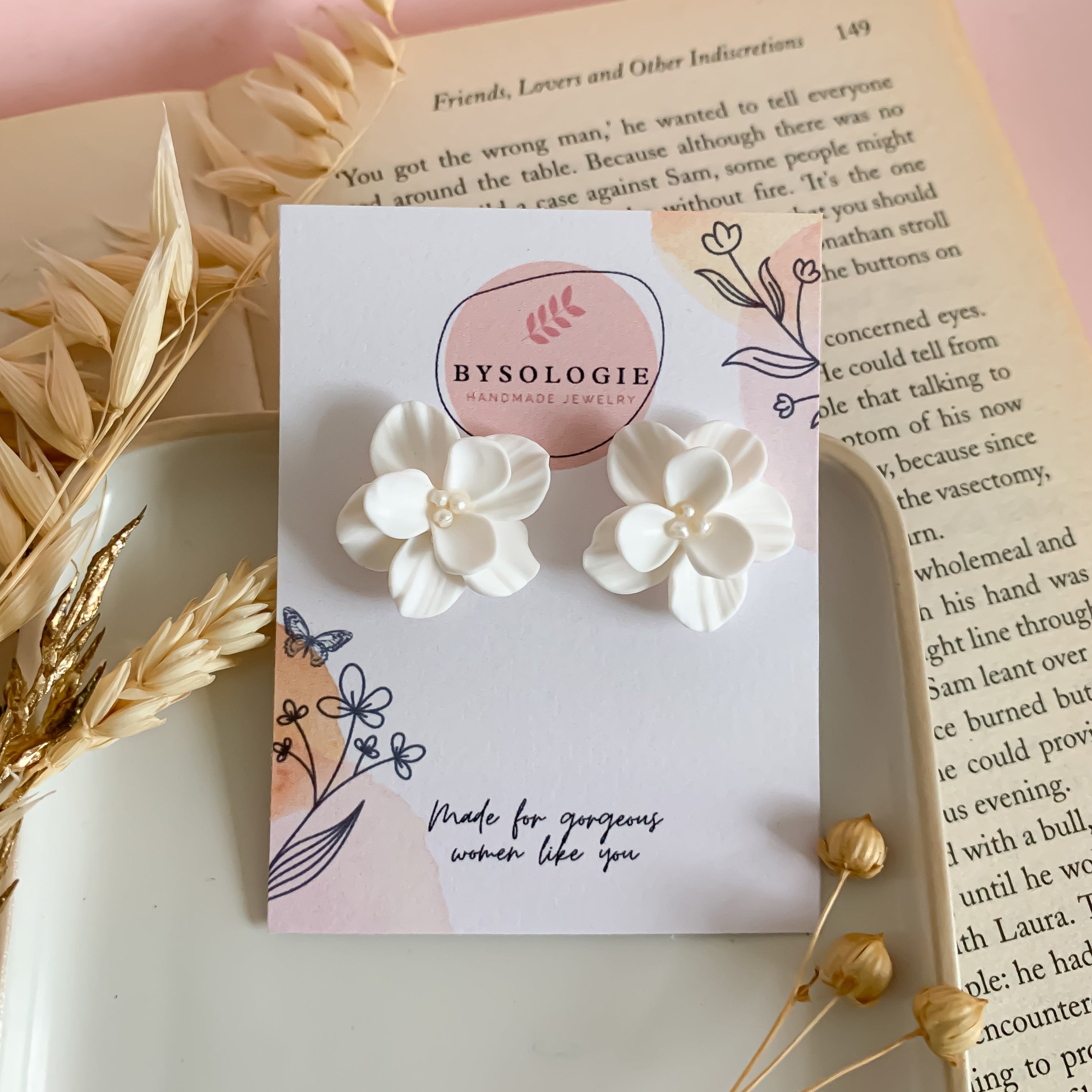 white flower stud earrings in display