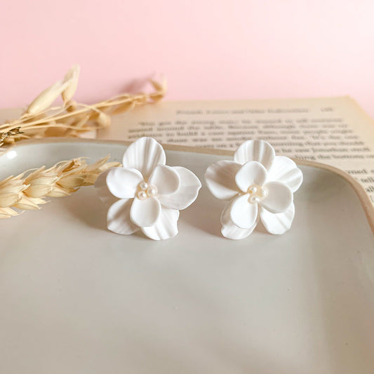 white stud earrings with double flower and tiny pearls in the center