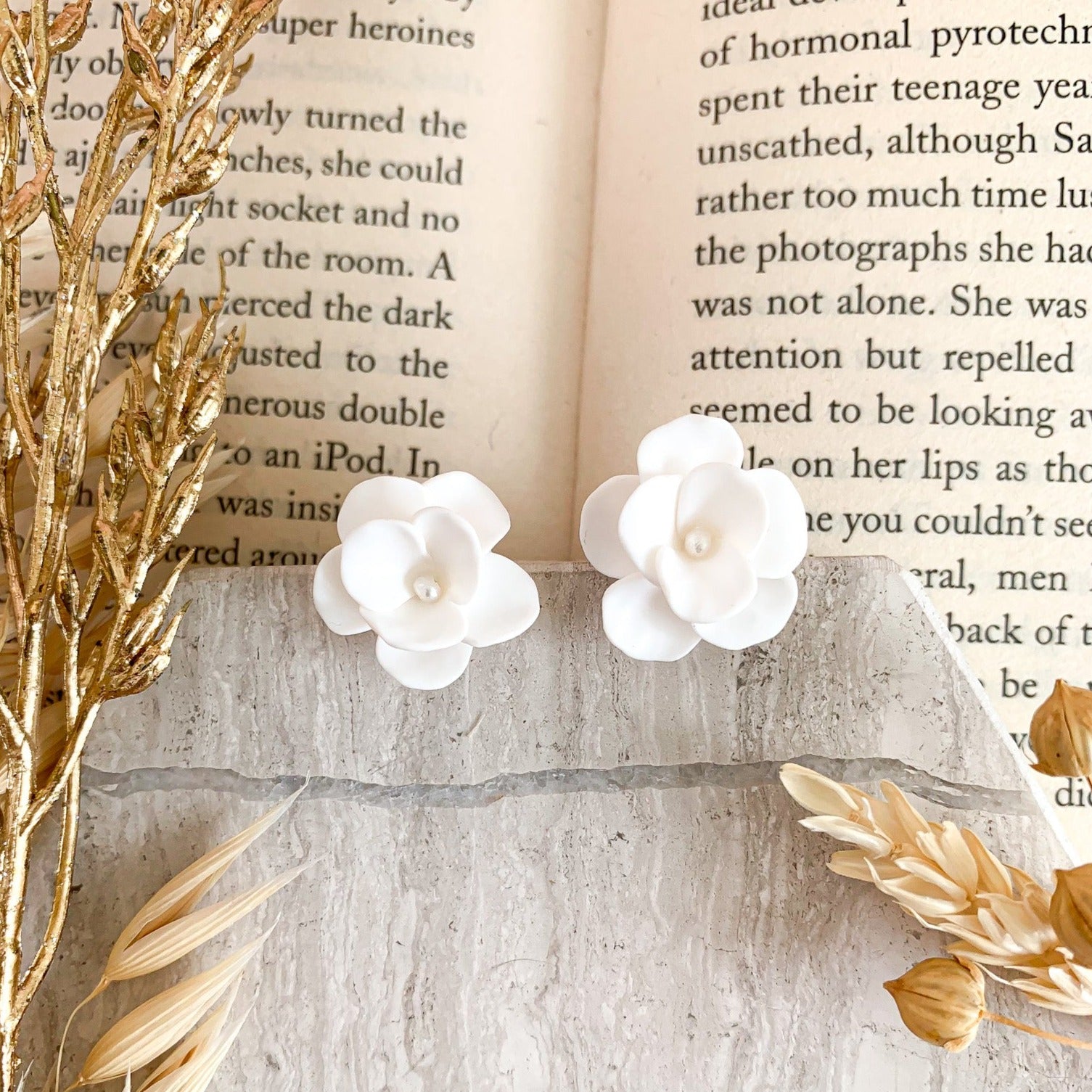 Small flower stud earrings handmade in polymer clay with a tiny pearl in the center