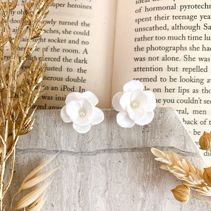 Small flower stud earrings handmade in polymer clay with a tiny pearl in the center