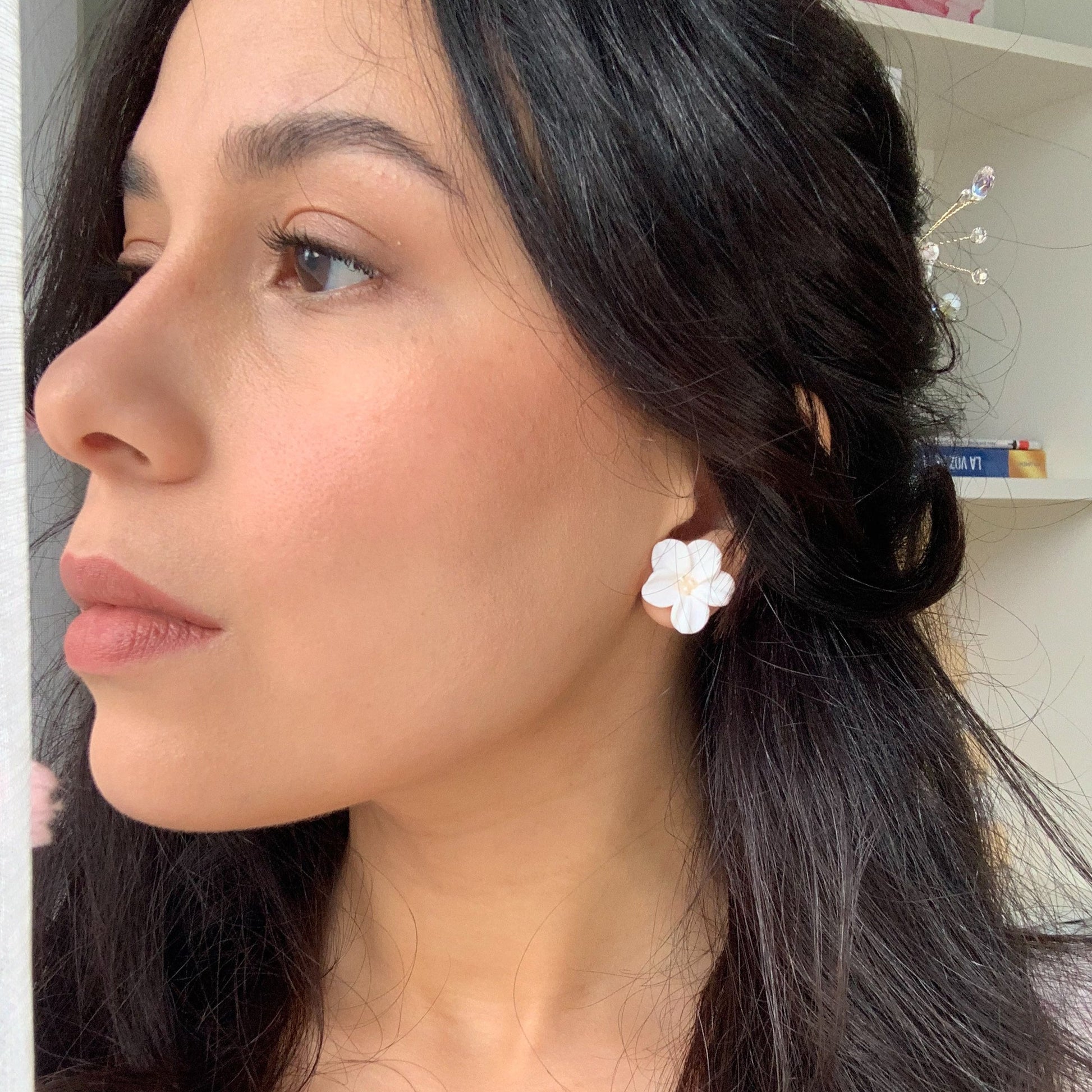 bride wearing dainty flower stud earrings