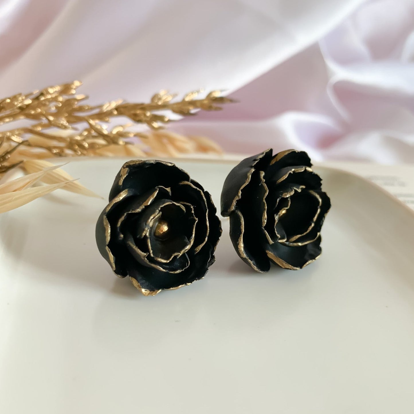 Black peony stud earrings with gold appliques