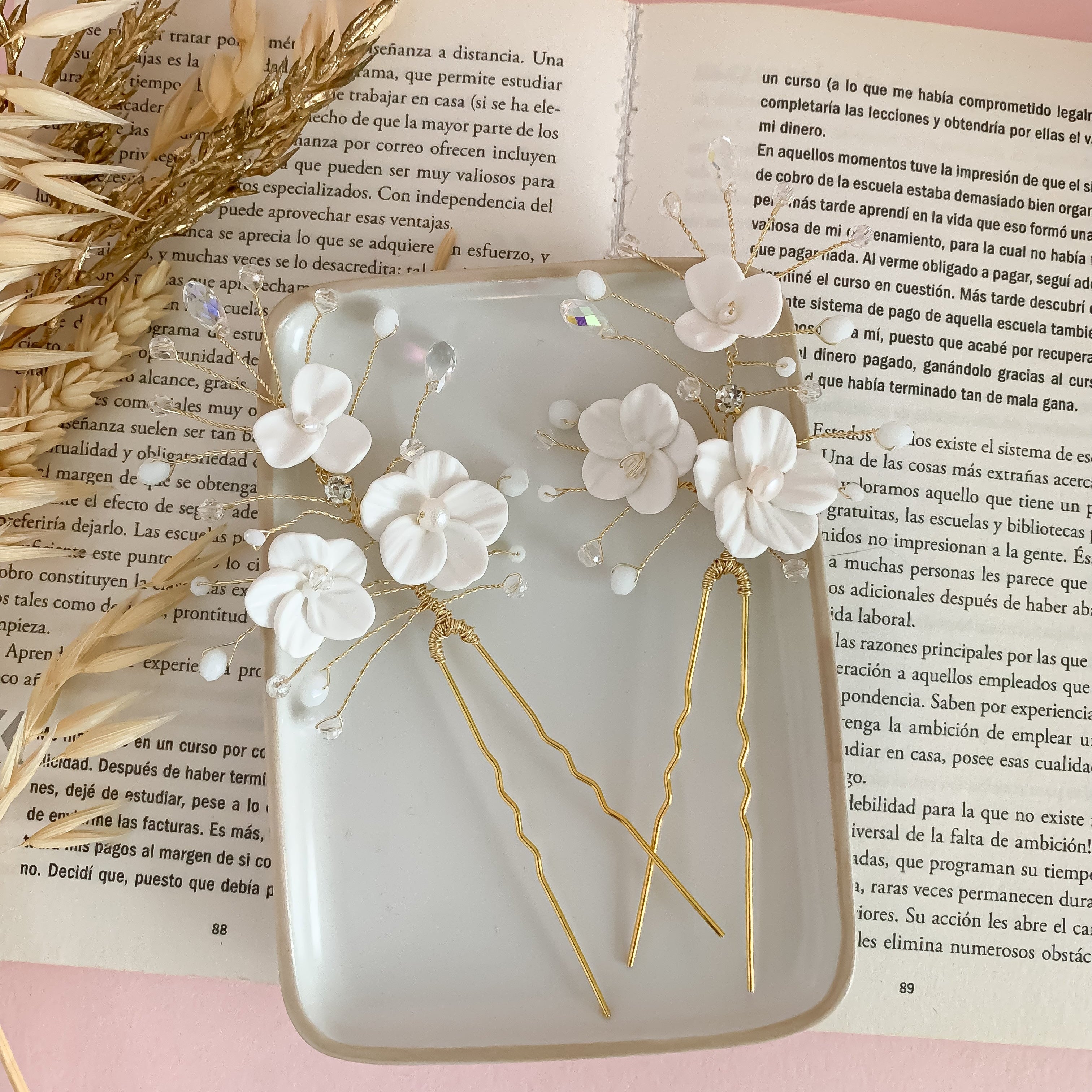 delicate floral hair pin designed for brides, featuring intricately crafted flowers with shimmering pearl centers and crystal accents.