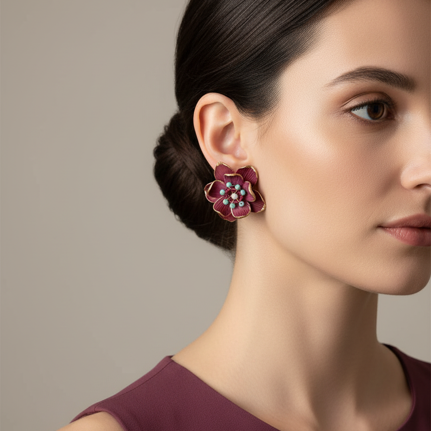 Woman wearing a floral earring in color burgundy