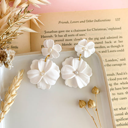 Double drop flower earrings in white polymer clay with a pearl in the center